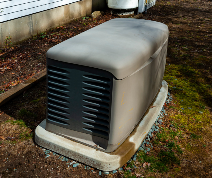 generator on concrete slab in backyard of a home