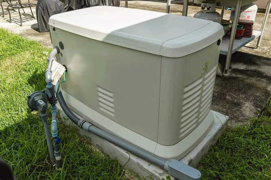 Generator on a concrete slab in the backyard of a home